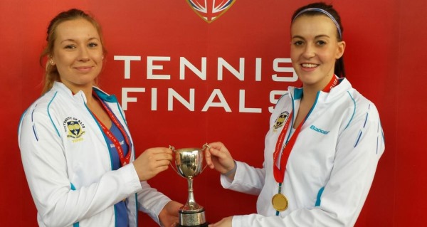 women's doubles winners holding the trophy