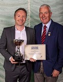 Graeme Manwell (left) receives the Gordon Brewis Service to Tennis Award from Ian Brown.