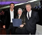 Margaret Robinson receiving the Lifetime Achievement Award from Roger Draper and John Last