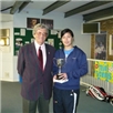 John Tucker presenting Ladies winner Virunee Viravong with winners trophy