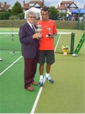 Marshall Tutu U18 and U21 winner receiving his trophy from John Tucker, ECLTA President 