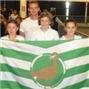 The Girls 10U Team holding the Wiltshire County flag with their coach Will Baillie 