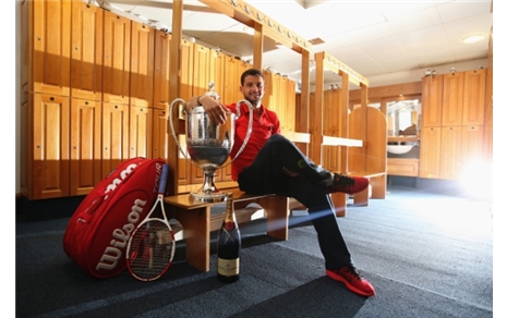LONDON, ENGLAND - JUNE 15:  Grigor Dimitrov of Bulgaria celebrates with the winners trophy in the players changing room after defeating Feliciano Lopez of Spain during their Men's Singles Final on day seven of the Aegon Championships at Queens Club on June 15, 2014 in London, England.  (Photo by Jan Kruger/Getty Images)